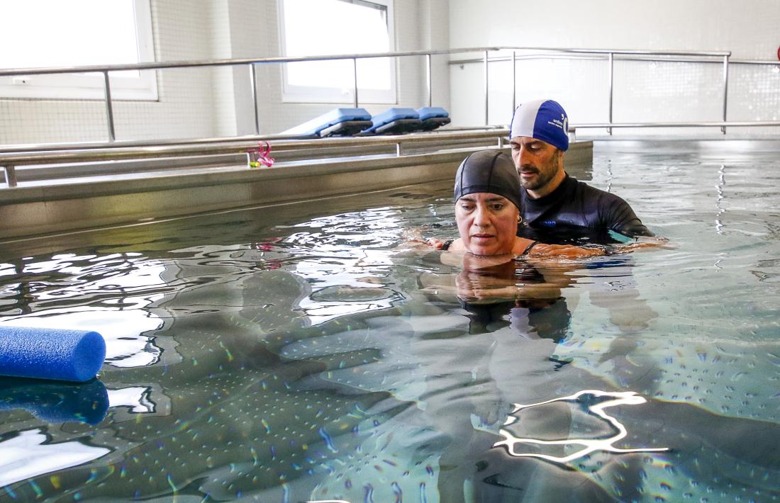 Un pacient amb una malaltia neurològica fa hidroteràpia amb un fisioterapeuta a la nova piscina de l’hospital. 